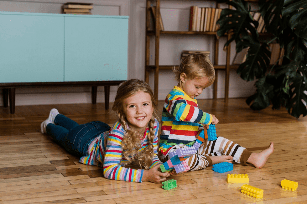 Little kid playing with colorful blocks in fun activities